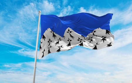 flag of department of Cotes d'Armor, France at cloudy sky background on sunset, panoramic view. French travel and patriot concept. copy space for wide banner. 3d illustrationの写真素材