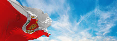 flag of Tlaxcala , Mexico at cloudy sky background on sunset, panoramic view. Mexican travel and...