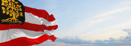 flag of Hertogenbosch , Netherlands at cloudy sky background on sunset, panoramic view. Dutch travel and patriot concept. copy space for wide banner. 3d illustrationの写真素材