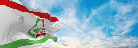 flag of Qiryat Gat , Israel at cloudy sky background on sunset, panoramic view. Israeli travel and patriot concept. copy space for wide banner. 3d illustrationの写真素材