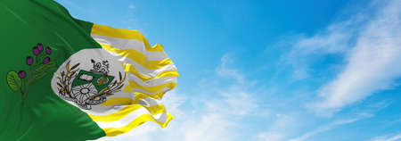 flag of Saskatoon , Canada at cloudy sky background on sunset, panoramic view. Canadian travel and patriot concept. copy space for wide banner. 3d illustrationの写真素材