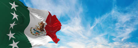 flag of presidential Mexico comandante supremo , Mexico at cloudy sky background on sunset,...