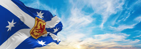 flag of Australian Scottish heritage , Australia at cloudy sky background on sunset, panoramic view. Australian travel and patriot concept. copy space for wide banner. 3d illustrationの写真素材
