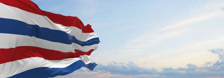 flag of the Secretary of Defence , Netherlands at cloudy sky background on sunset, panoramic view. Dutch travel and patriot concept. copy space for wide banner. 3d illustrationの写真素材