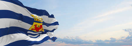 flag of Zeeland , Netherlands at cloudy sky background on sunset, panoramic view. Dutch travel and patriot concept. copy space for wide banner. 3d illustrationの写真素材
