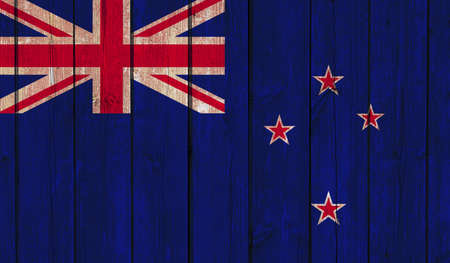 Top view of Old Painted Flag of New Zealand on Dark Wooden Fence, wall. patriot and travel concept. no flagpole. Plane design, layout. Flag backgroundの写真素材