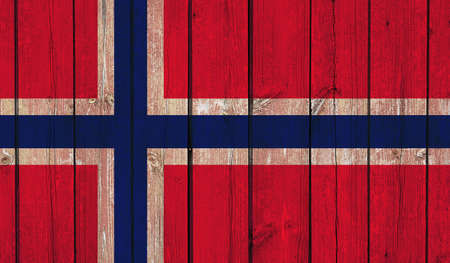 Top view of Old Painted Flag of Norway on Dark Wooden Fence, wall. patriot and travel concept. no flagpole. Plane design, layout. Flag backgroundの写真素材