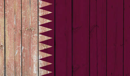 Top view of Old Painted Flag of Qatar on Dark Wooden Fence, wall. patriot and travel concept. no flagpole. Plane design, layout. Flag backgroundの写真素材