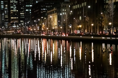 Night view of business district and watersideの写真素材