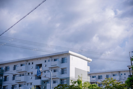 Residential building with blue sky and white cloud background in Japan.