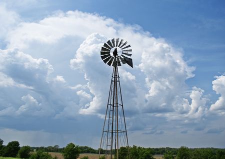 windmill in front of storm cloudの写真素材