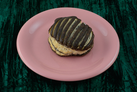 Chocolate breakfast pastry on pink plate