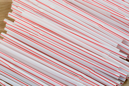 Pile of flexible drinking straws with red stripeの写真素材