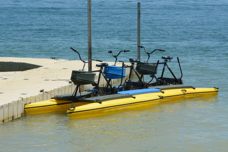 Pedal boats tied up to the dock at lake in public park