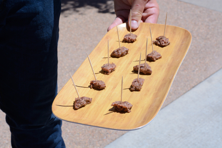 Samples of Angus beef appetizers on tooth picks offeredの写真素材