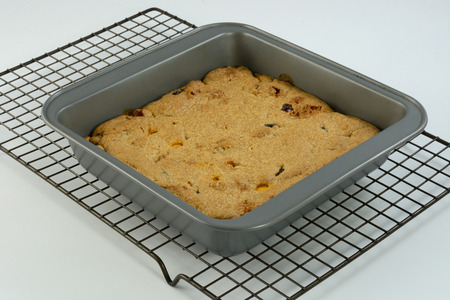 Pumpkin spice blondies with dried cranberries, caramel bits and marshmallow bits in baking pan on...
