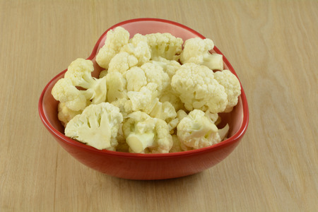 Heart healthy cauliflower florets in red heart shaped bowlの写真素材