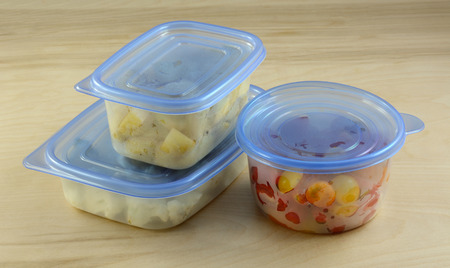 Chopped dinner ingredients of cauliflower, potatoes and cherry tomatoes in plastic refrigerator storage containers prepared in advance for quicker cooking during week after workの写真素材