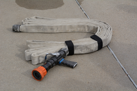 Inspected fire hose arranged and tied in preparation of placement in fire engineの写真素材