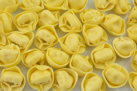 Close up of dry uncooked raw tortellini cheese stuffed pastaの写真素材