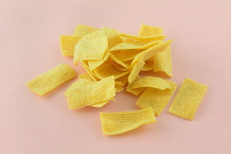 Salted crisp crunchy lentil chips snack food on pink background