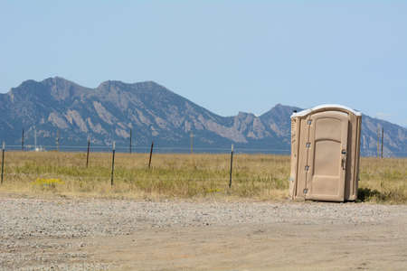 Piles of recycled asphalt and bitumen to be recycled for making roads with Rocky Mountains in...
