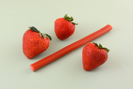 Strawberries and a straw on a white background, close-upの写真素材