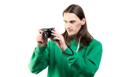 Portrait of a young handsome man in green hoodie looking at the camera on a white background. Lifestyle, people and technology conceptの写真素材