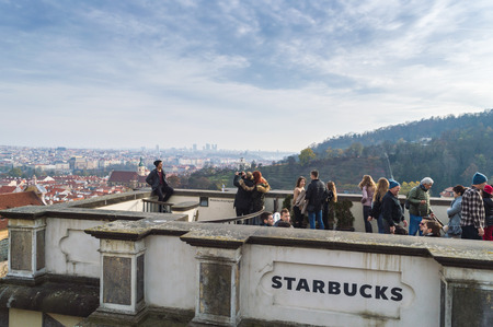 Prague, Bohemia / Czech Republic - November 2017: Tourists taking photos of themselves and city view from the open terrace of Starbucks cafe near Prague castle, Hradcanyのeditorial素材