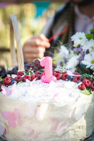 First year birthday cake with cream and berriescloseup, selective focusの写真素材