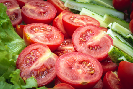 Fresh vegetables closeup: lettuce, tomatoes, cucumbers.の写真素材
