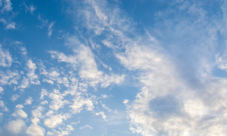 Blue bright summer sky with fluffy clouds on a sunny day.の写真素材