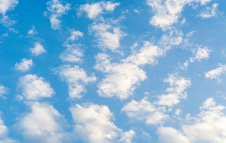 Blue bright summer sky with fluffy clouds on a sunny day.の写真素材