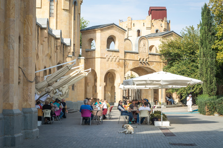 Tbilisi, Georgia - October 2018: people and dogs in the cafe on the territory of the Holy Trinity Cathedral commonly known as Sameba in Tbilisi, Georgia.のeditorial素材