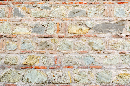 Abstract background of ancient old colourful brick layered ground with weathered surfaceの写真素材
