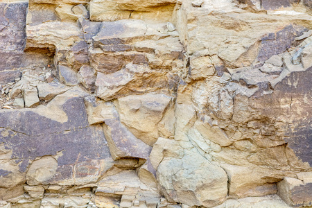 Simple background of ancient cracked and shabby rock formationの写真素材