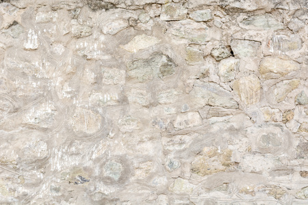Abstract background of ancient old stone wall with weathered surfaceの写真素材