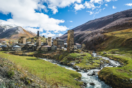 Picturesque landscape of aged Georgian rural community Ushguli in valley of beautiful mountains with snowy peaksの写真素材