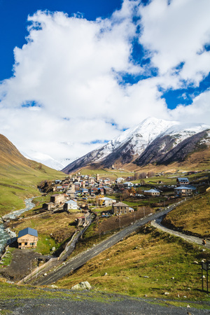 Picturesque landscape of aged Georgian rural community Ushguli in valley of beautiful mountains with snowy peaksの写真素材