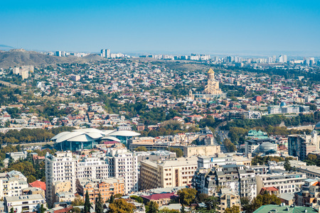 Tbilisi cityscape from a view point on a clear day showing old and modern architecture with...