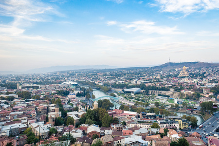 Tbilisi cityscape from a view point on a clear day showing old and modern architecture with mountains in the background, Georgiaの写真素材