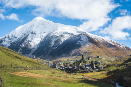 Picturesque landscape of a road to aged Georgian rural community Ushguli in valley of beautiful mountains with snowy peaksの写真素材