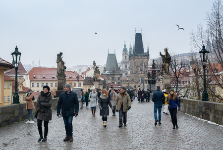 Prague, Czech Republic - December 2018: tourists walking on the Charles bridge with view on Prague castle and Vltava riverのeditorial素材