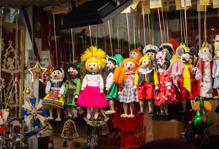 Wooden colourful toys and dolls at the traditional Christmas market in Prague, selective focusの写真素材