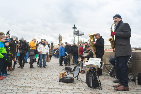 Prague, Bohemia, Czech Republic - December 2018: A musical jazz band playing on the famous Charles bridge, tourist walking around and listeningのeditorial素材