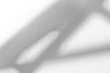 Light from sunlight with abstract window shadow on white wall texture background, architect...