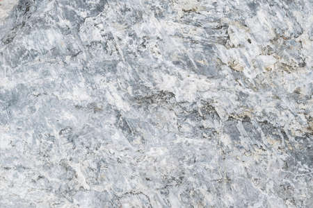 Stone texture abstract background. Detail of natural material gray and white granite old rock wall...