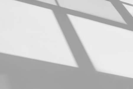 Light from sunlight with abstract shadow on white wall texture background, architect geometric construction window pattern on gray empty building wall surface for template presentation and any designの写真素材