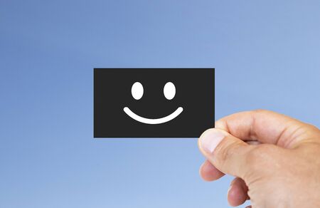 Man holding black business card. happy and reliable smile icon. isolated backgroundの写真素材