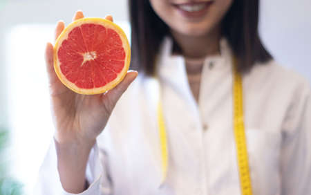 nutritionist holding bowl of mixed fruit